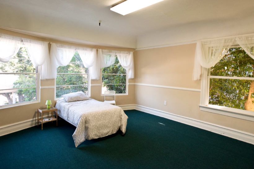 A bedroom with garden views at Promise Assisted Living